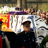 Soldiers accompany a gun carriage holding the coffin bearing the Queen Mother April 5, 2002.