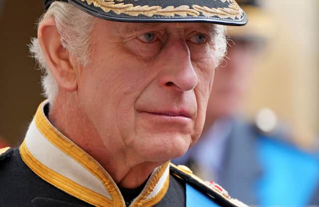 King Charles III follows the coffin of Queen Elizabeth II as it travels inside Windsor Castle on September 19. 