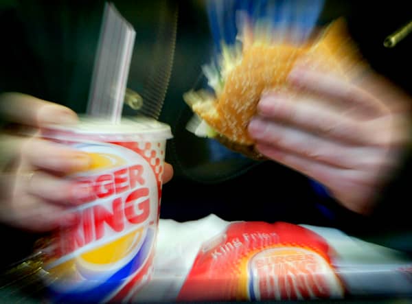 <p> A man eats his lunch at a Burger King restaurant.</p>