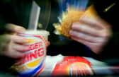 A man eats his lunch at a Burger King restaurant.