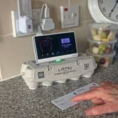 Pensioner Diane Skidmore examines her smart meter in London. 