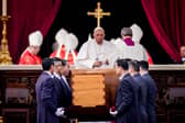 Pope Francis attends the funeral mass for Pope Emeritus Benedict XVI as pallbearers carry the coffin at the end of the funeral mass at St. Peter's square