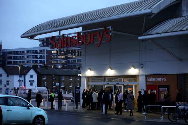 People queue outside the Sainsbury’s  after reports they would be stocking the in demand drink