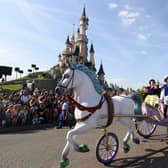 Crowds watch as Snow White and her prince ride past on a carriage during the Main Street Parade at Disneyland Paris.