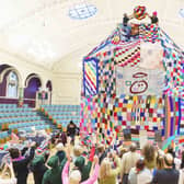 People watch as workers place a giant bobble on top of a 23 foot high bobble hat in celebration of the 20th anniversary of the innocent Big Knit in partnership with Age UK (photo: Dominic Lipinski/PA Wire)