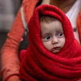 A Ukrainian woman holds her 3-month-old baby at the Western Railway Station as they flee Ukraine on March 9, 2022 in Budapest, Hungary. 