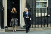 Prime Minister Boris Johnson and his partner Carrie Symonds stand outside the door of number 10 Downing Street (Photo by Leon Neal/Getty Images)