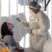 A woman receives a nasal swab, from a health worker wearing personal protective equipment (PPE), to be tested for COVID-19 at the Fourways Life Hospital in Johannesburg (Getty Images)