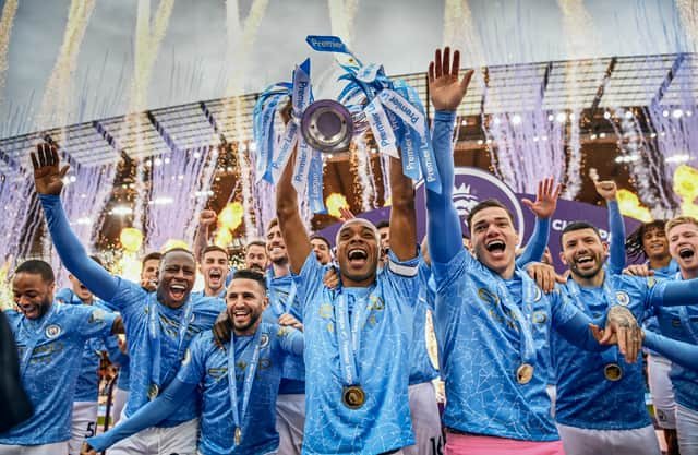 Fernandinho of Manchester City lifts the Premier League Trophy with team mates (Photo by Michael Regan/Getty Images)