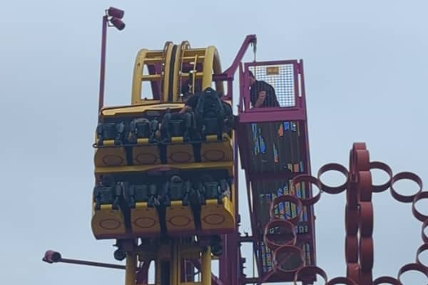 Horrified onlookers watched as rescuers scrambled to the aid of eight terrified people stuck “at the top” of a 22-metre rollercoaster.