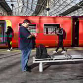 Commuters walk past a train stopped at a platform in Waterloo Station in London, during a national strike day, on February 1, 2023.