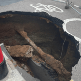 Mysterious sinkhole appears in UK and almost gobbles post box - motorists beware 