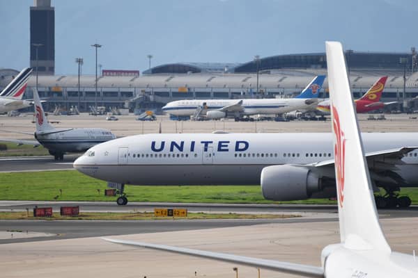 Footage captured of the moment a wheel fell off of a United Airlines Boeing 777 during takeoff, crushing cars below. Picture: Getty Images