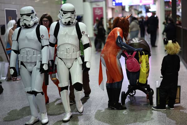 Cosplayers attend the MCM Comic Con at ExCeL exhibition centre in London on October 27, 2023. (Photo by HENRY NICHOLLS / AFP) 