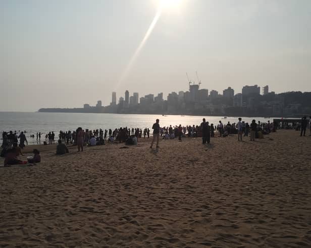 Families gather before sunset on Chowpatty beach in Mumbai