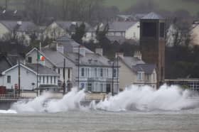 Waves break against the sea wall in Carnlough on the north east coast of Northern Ireland early in the morning of January 24, 2025, as storm Eowyn brings winds of 100 mph to the UK and Ireland.