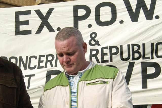 Tony Taylor, beside a banner reading 'Ex-POWs and Concerned Republicans Against RUC/PSNI', handling ectasy tablets he claimed to have confiscated in Creggan, Londonderry