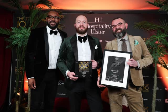 Willard D Barber and Michael Murphy, McConville’s Portadown receiving their Hospitality Ulster Top 100 Award from former England Rugby player Ugo Monye.