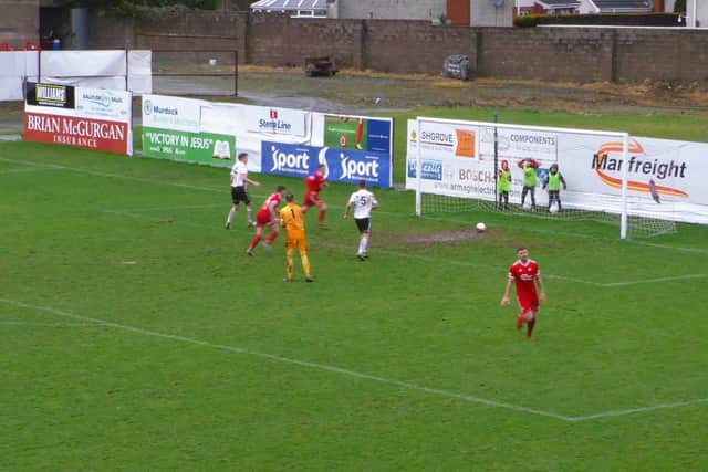 Portadown's Adam Salley thinks he's scored against Queen's University only to be denied by a muddy goalmouth