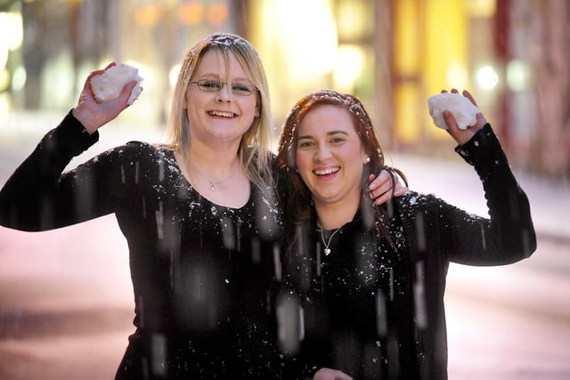 Rachael Wood, left, and Lauren Picken, bar staff at the Blue Lounge on 
St Nicholas Street, have a quick snowball fight outside.