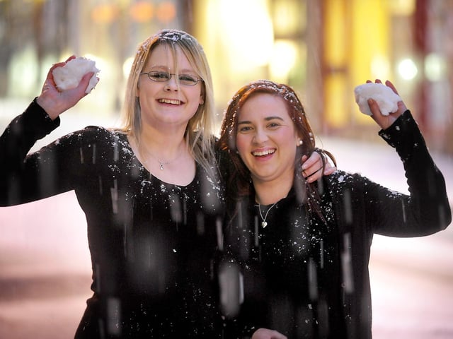 Rachael Wood, left, and Lauren Picken, bar staff at the Blue Lounge on
St Nicholas Street, have a quick snowball fight outside.