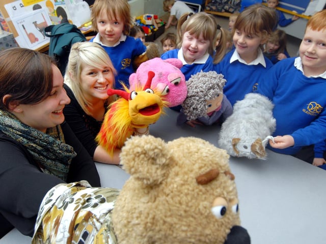 Pupils at Gladstone Road Infants School learn about puppets with Diana Logan, who introduces the puppets to the children.