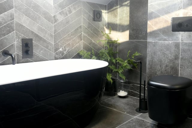 The main bathroom is both striking and restful with the bath, black loo and Crosswater taps sourced from Yorkshire-based MKM plus tiles from Mandarin Stone.
