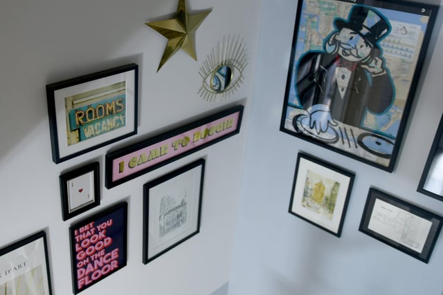 Amanda and Tom have a vast collection of pictures, many of which are on their stairway feature wall