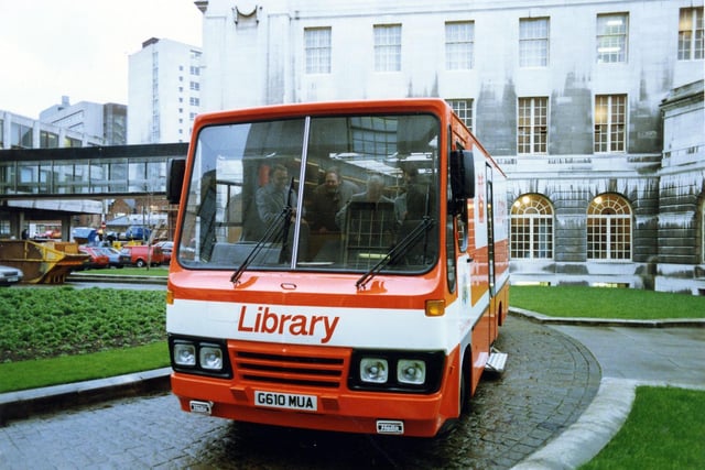 One of Leeds City Libraries' Mobile Libraries on the circular roadway in the grounds to the rear of Leeds Civic Hall. The glass bridge linking the Civic Hall to its annexe can be seen to the left. The tall building partly visible behind this is Leeds College of Technology.