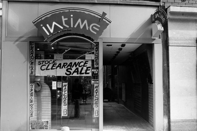 Intime Jewellers on Lands Lane pictured in April 1989. Posters advertise a stock clearance sale with watches at half price. A passageway on the right leads to the back of the shop.