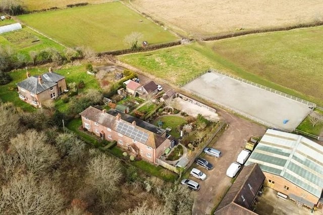 The house is set behind a pretty front garden enclosed by a picket fence, with a generous gravel parking area to the rear accessed by a shared driveway. Picture: Hamptons - Haywards Heath Sales.