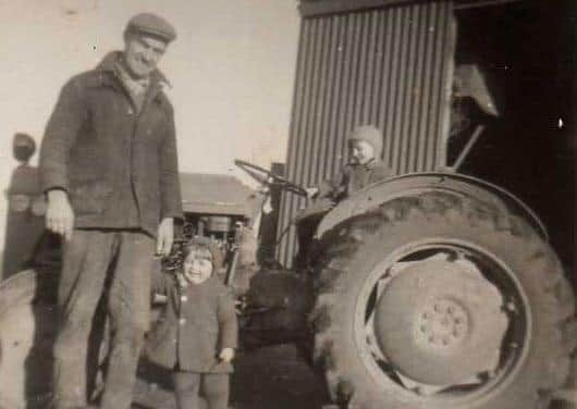 Edwin McFadden says: â€œThis photo shows uncle Jim with Alan on the old Ferguson TVO and myself holding my uncleâ€TMs hand.â€