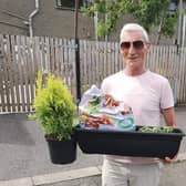 Dunvale resident Mr Clarke receiving his window box as part of
the Little Bit of Paradise Project, funded through the Housing Executive’s
Covid-19 Response Fund and delivered by Dunclug youth Forum.