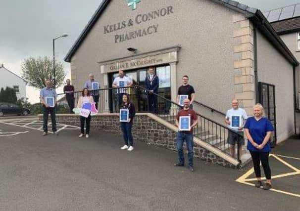 Kells & Connor Pharmacy receive their certificates of recognition from the Maupr of Mid and East Antrim, Councillor Peter Johnston.