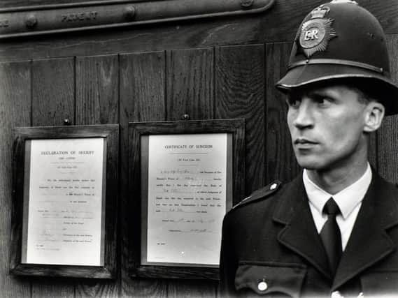 On the left, in a black wooden frame was the declaration of sheriffs. It read: We, the undersigned, hereby declare that the judgment of death was this day executed in Her Majesty Prison of Holloway in our presence. Dated this 13th day of July, 1955.