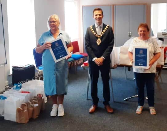 Janice Cherry, project co-ordinator (left), and Ann Mayne, voluntary director, with the Mayor of Mid and East Antrim, Cllr Peter Johnston.