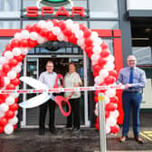 The store was officially opened by Bertie Tyrrell  (centre). He was joined by his wife Kate who also worked for the company. Also pictured is store manager Andrew McIleese (left) and area manager, Ian Mullin (right).