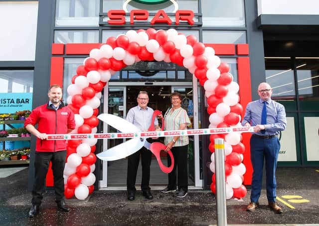 The store was officially opened by Bertie Tyrrell (centre). He was joined by his wife Kate who also worked for the company. Also pictured is store manager Andrew McIleese (left) and area manager, Ian Mullin (right).