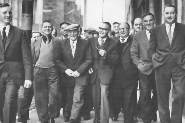 Shipyard workers arriving at the Grosvenor Hall in Belfast in May 1965 to attend a mass meeting to discuss the labour dispute which had lead to a two week strike. More than 3,500 men were made idle because of the dispute between the Boilermakers Society and management. By the end of the meeting it had been agreed that it was back to work, a decision which the News Letter noted was welcomed by both sides of the strike. (NEWS LETTER ARCHIVES)
