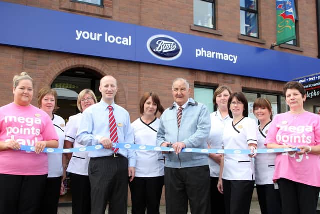 Long time customer of the old Salisbury Chemists, Alexander Stewart cuts the ribbon to mark the official opening of the new Boots Pharmacy on the same site in Harryville. Included are store manager Peter Diamond and staff members Claire, Anne Marie, Leanne, Karla, Heather, Margaret and Laura. BT32-100JC