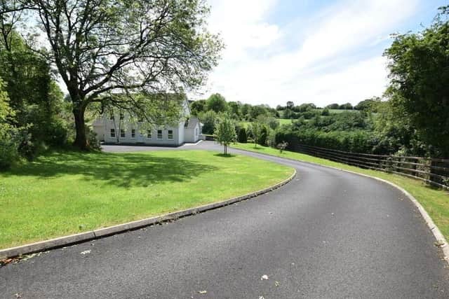 The property has a gated entrance with tarmac driveway