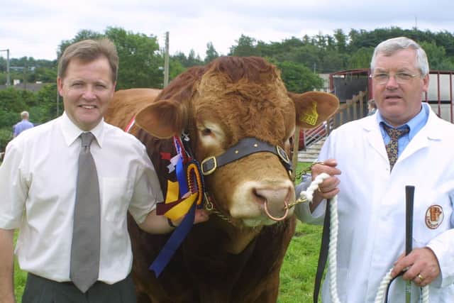 Bob Esler presents the Ulster Bank Limousin champion prize at the Antrim Show in 2002 to Liam Campbell. Picture: Kevin McAuley