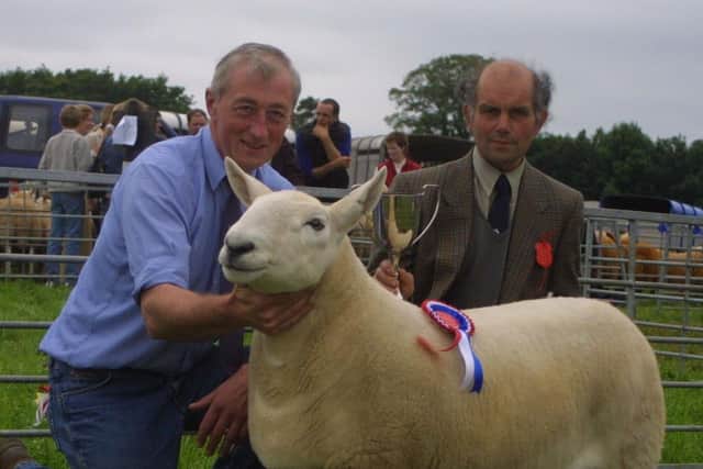 John Devine who won the North Country Cheviot class at the Antrim Show in 2002 is pictured with judge Tom McKean. Picture: Kevin McAuley