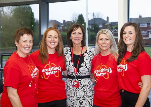 Pauline Millar, head of respiratory services at NI Chest Heart & Stroke, pictured before social distancing measures were introduced, with Kerry Marsh (left), the charity’s respiratory co-ordinator in the Northern Trust area and other members of the team.