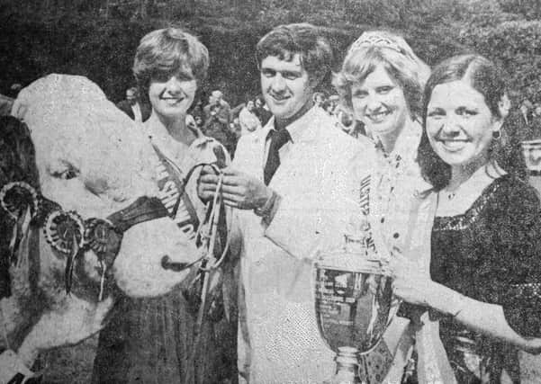 1979 - Mr. Andrew Patterson, holding "Sacombe Edgar" owned by Mr. Bertie Waterson, winner of the Simmental and Beef championships at the Antrim Show, receiving his trophy from Karen McCalmont (Co. Antrim Dairy Princess), Sally Moore (Ulster Dairy Queen) and Patricia Robson (Antrim Show Queen). INAT30-701F