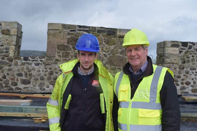 James McNicholl (left) of JPM Contracts and Joe Mahon up on the roof of Carrickfergus Castle