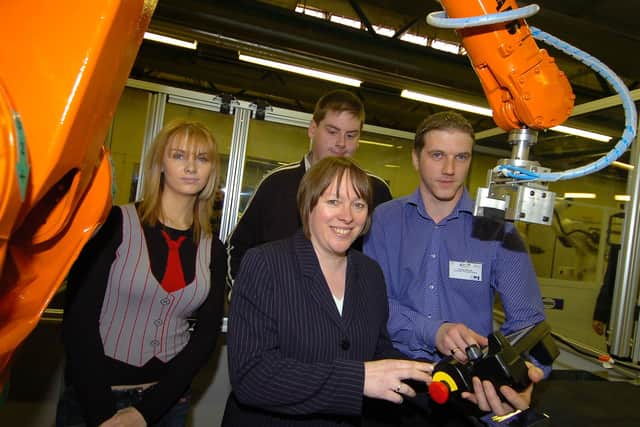 Alastair Mitchell, Technician at North East Institute, showing Maria Eagle, Minister for Employment and Learning, how to operate a robotic arm at North East Institute, during the minister's visit to the Institute to help celebrate the achievements of a robotics project. BT49