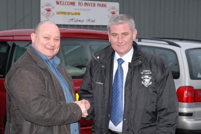 The winner of the VIP for day competition, Ian White, is congratulated by Larne Football Club chairman Wesley McGookin. LT01-356-PR