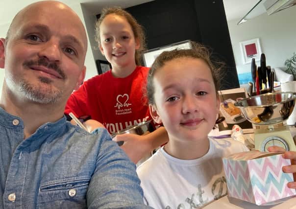 Nigel Armstrong with twin daughters Lily, 11 (centre back) and Sine, 11