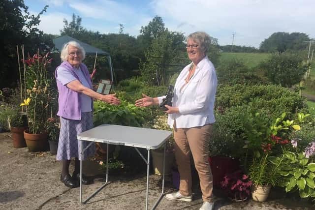 Eileen McFall receives the Intermediate Award from Ballymena Floral Art Group chair, Gladys